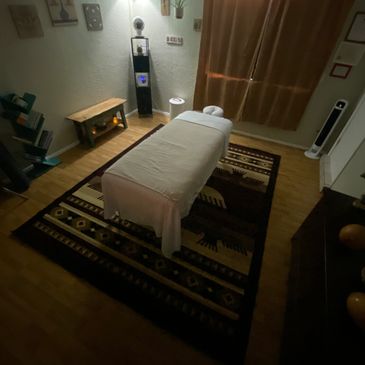 Cozy massage room with soft lighting and a comfortable table.