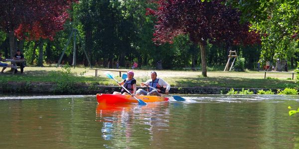 A man and a woman  canoeing on the River Charente. 