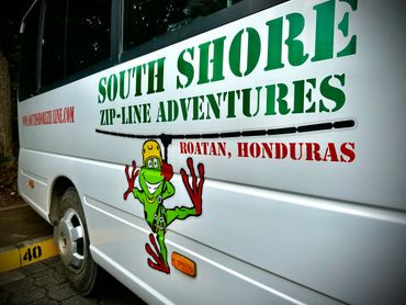 Bus advertising South Shore Zip-Line Adventures in Roatan, Honduras.