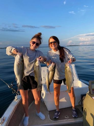 A picture of two girls with fishes