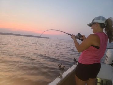 A picture of a woman pulling a fishing rod