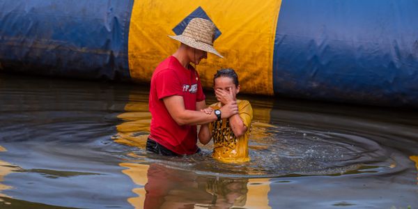 Elliott Cox baptizing a Rider after the chapel service.