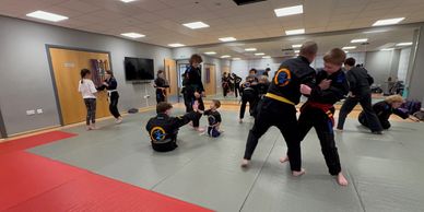 Families practising Ju Jitsu and self-defence together at Winchester School of Martial Arts.