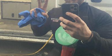 Man taking selfie with a peace sign in a workshop.