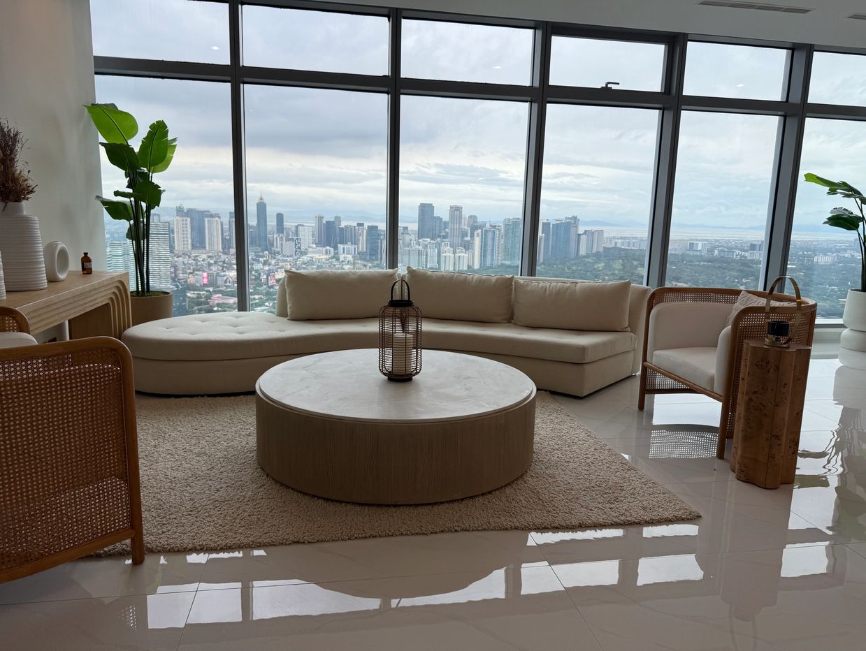 Modern living room with large windows overlooking a city skyline.