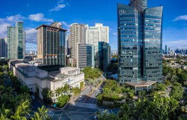 Modern cityscape with tall buildings and clear skies.
