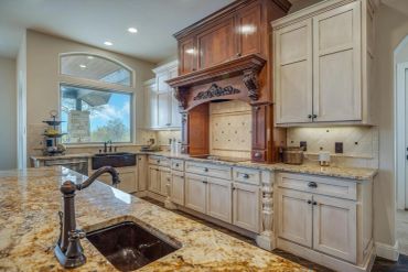 Elegant kitchen with granite countertops and wooden cabinetry.