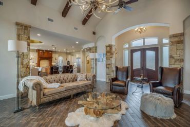 Elegant living room with rustic wooden floors and stone accents.