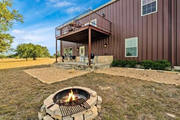 Modern house with fire pit in backyard.