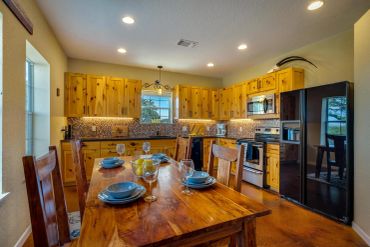 Cozy wooden kitchen with dining table set.
