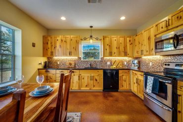 Cozy rustic kitchen with wooden cabinets and modern appliances.