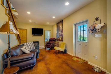 Cozy living room with leather chairs and rustic decor.