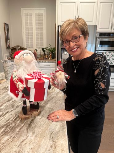 2025 Christmas Wonky Santa gifting an ornament. 