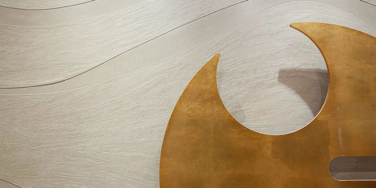 Marmorino Polished Plaster product used to create a Travertine wave wall design for Powder Room 
