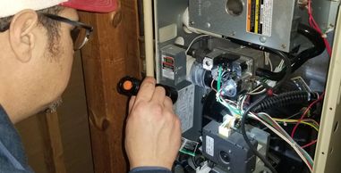 Eddie Rose inspecting a High Efficiency furnace.