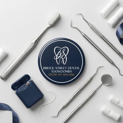 Dental tools and accessories arranged around a Bridge Street Dental Toowoomba coaster.
