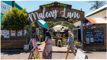 Entrance to Maleny Lane food market with people walking.