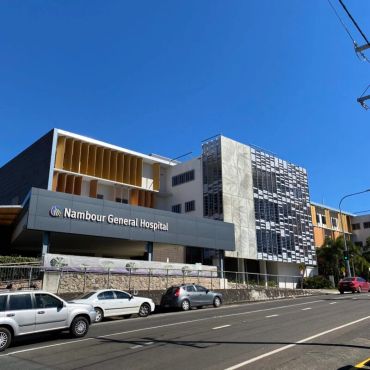 Nambour General Hospital building under blue sky.