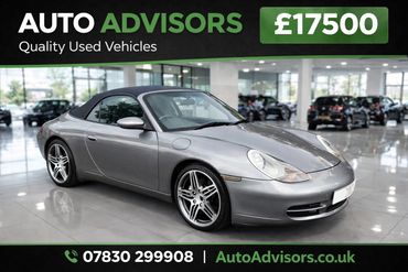 Silver convertible sports car displayed in a showroom with price and contact info.