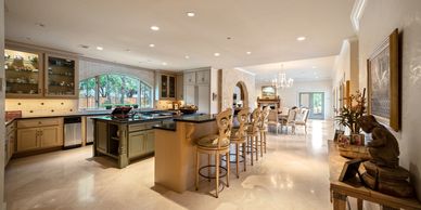 Spacious kitchen with bar seating and elegant decor.