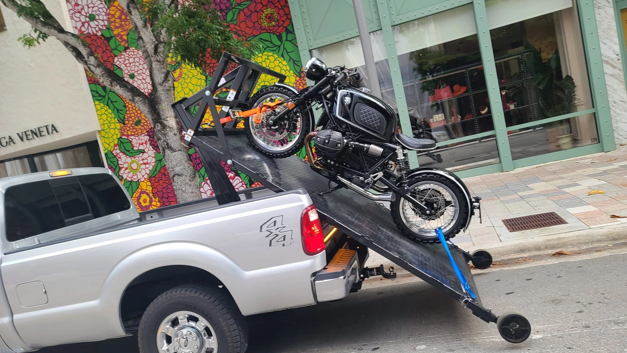 Motorcycle towing using a flatbed lift.