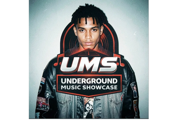 Young man in a patch-covered jacket with UMS Underground Music Showcase logo.