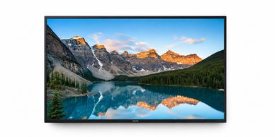 TV showing mountain landscape reflected in lake.