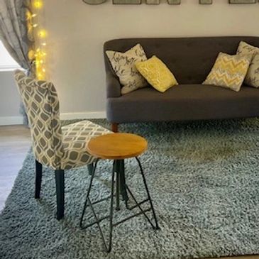 Cozy seating area with fairy lights and 'Life Center' sign on wall.