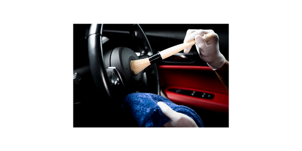 Detailer cleaning interior of a car.