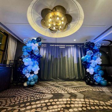 Illuminated balloon wall with string lights creating an elegant evening backdrop.