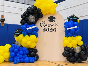 Graduation balloon display for Class of 2026 installed in school gymnasium.