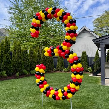 Seven-foot outdoor balloon number  three display installed in a yard for a birthday party 