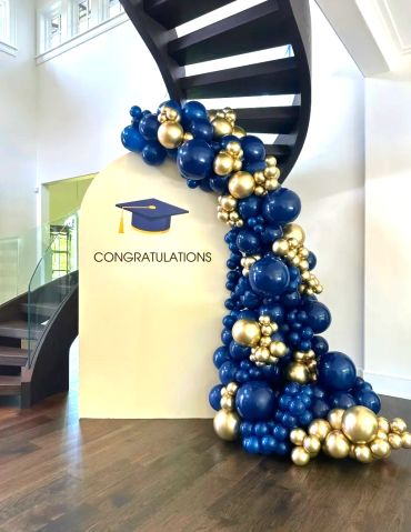 Graduation decoration with blue and gold balloons.