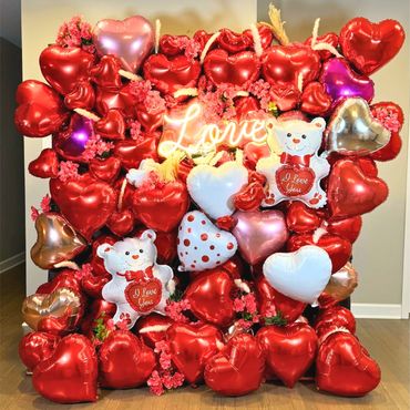 Hearts balloon wall with flowers, pampas grass, and neon sign—adds instant excitement and sweetness.