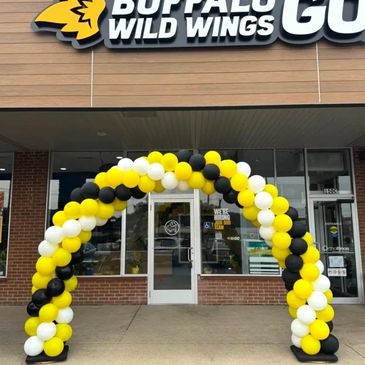 Structured balloon arch placed of the door for the grand opening.