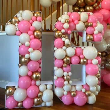 Marquee mosaic numbers 16 filled with pink, white, and gold balloons in different sizes.