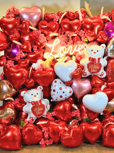 Heart-shaped balloons and teddy bears with love theme.