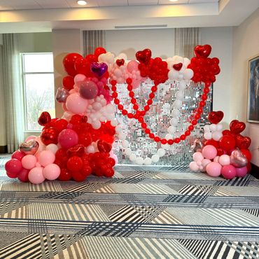 Sequin wall with rich pink and red balloons—creates a stunning, eye-catching Valentine’s display.