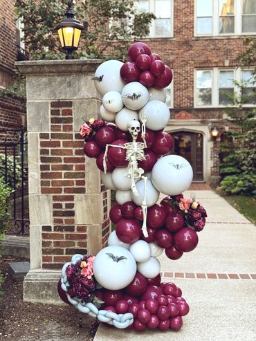 Sangria and gray balloon garland with skeleton, bats, florals, and chains.