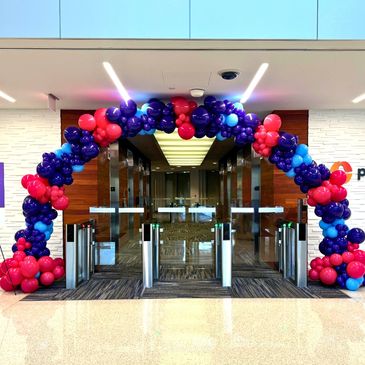 A balloon arch surrounding the gate, creating the festive entrance.