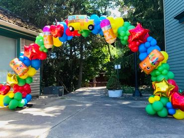 Festive balloon arch with school bus, stars, and pencils, perfect for kicking off new school year.