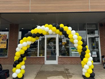 Stylish structured arch for a grand opening, designed with colors that reflect the company logo.