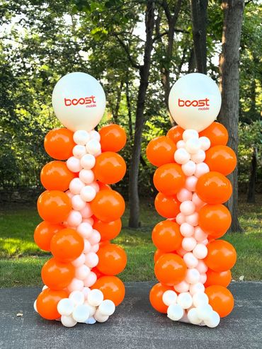 Two balloon columns with a company logo, perfect for enhancing event decor.