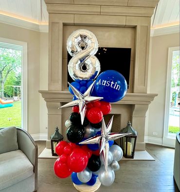 Large birthday balloon bouquet with number 8, starburst stars, and personalized jumbo balloon. 
