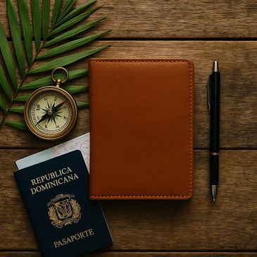 Notepad sits on a table next to a pen, compass and Dominican Republic passport.