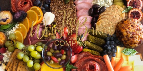 A colorful charcuterie board with fruits, cheeses, crackers, and meats.
