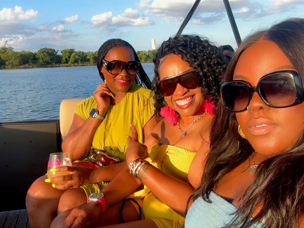 Three women enjoying a sunny day on a boat.