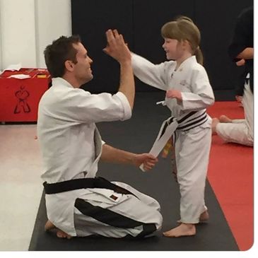 Afterschool martial arts student giving a high five