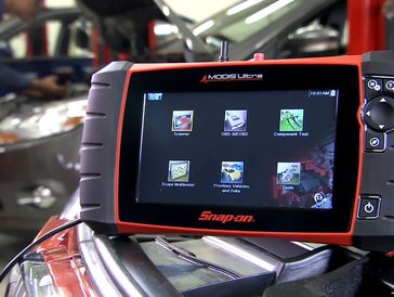 Snap-on diagnostic tool displaying various automotive test options.