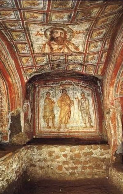 Ancient Christian frescoes adorn a stone chapel interior with religious figures.